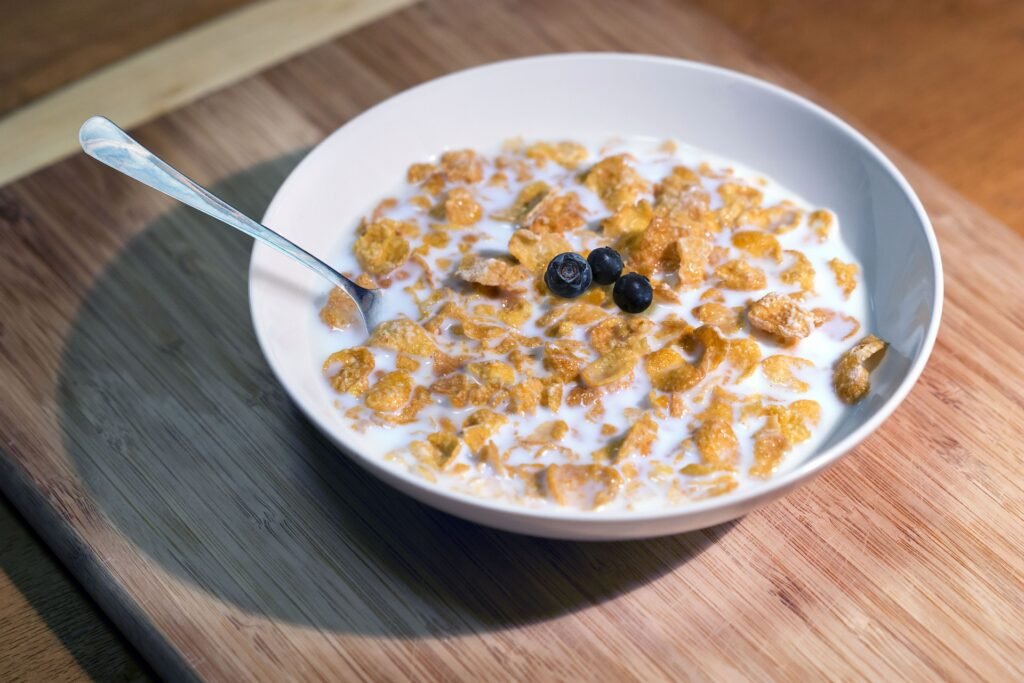 Blueberries added to a bowl of cereal for breakfast